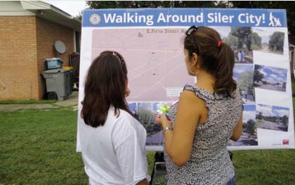 National night out photo. Two people review walking plan